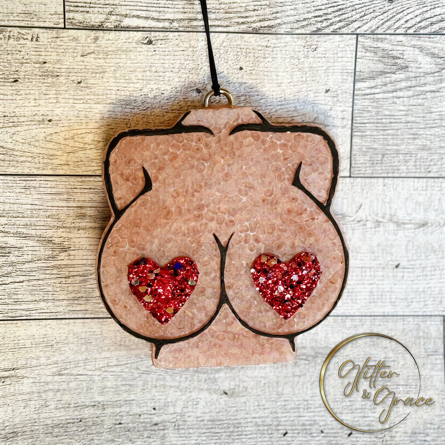 vehicle air freshener in the shape of a womans body with hearts in red glitter as pasties over her nipples