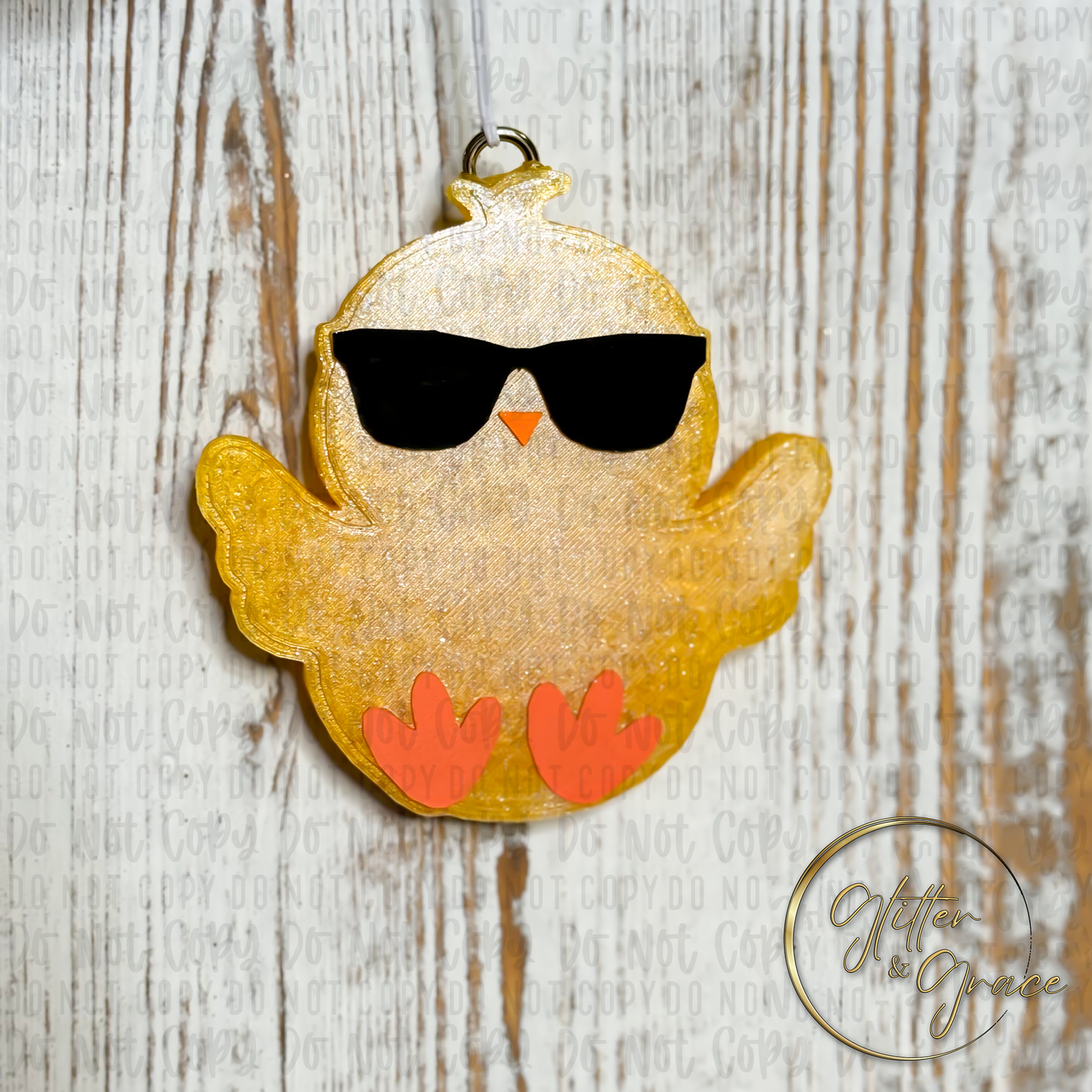 vehicle air freshener shaped like a chick wearing sunglasses