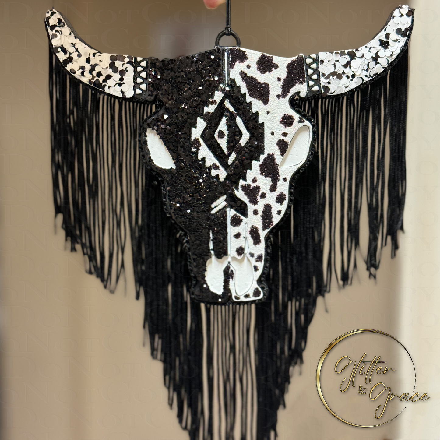 aztec bull decorated half with black glitter and half with a cowhide look