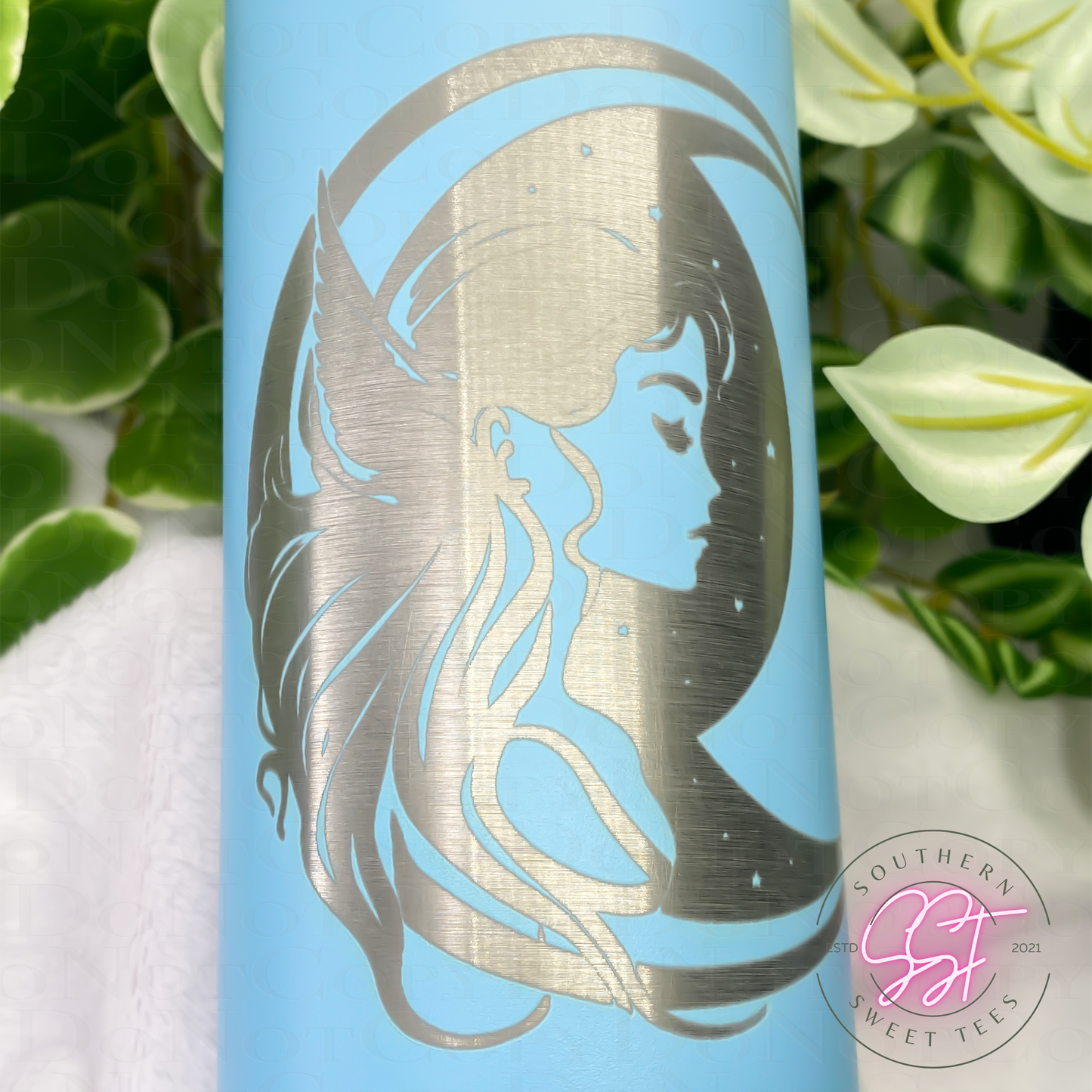 20oz skinny powder coated tumbler in sky blue color laser engraved with a fairy and moon