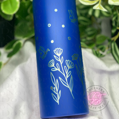 20oz skinny powder coated tumbler in blue laser engraved with florals and butterflies all the way around the tumbler