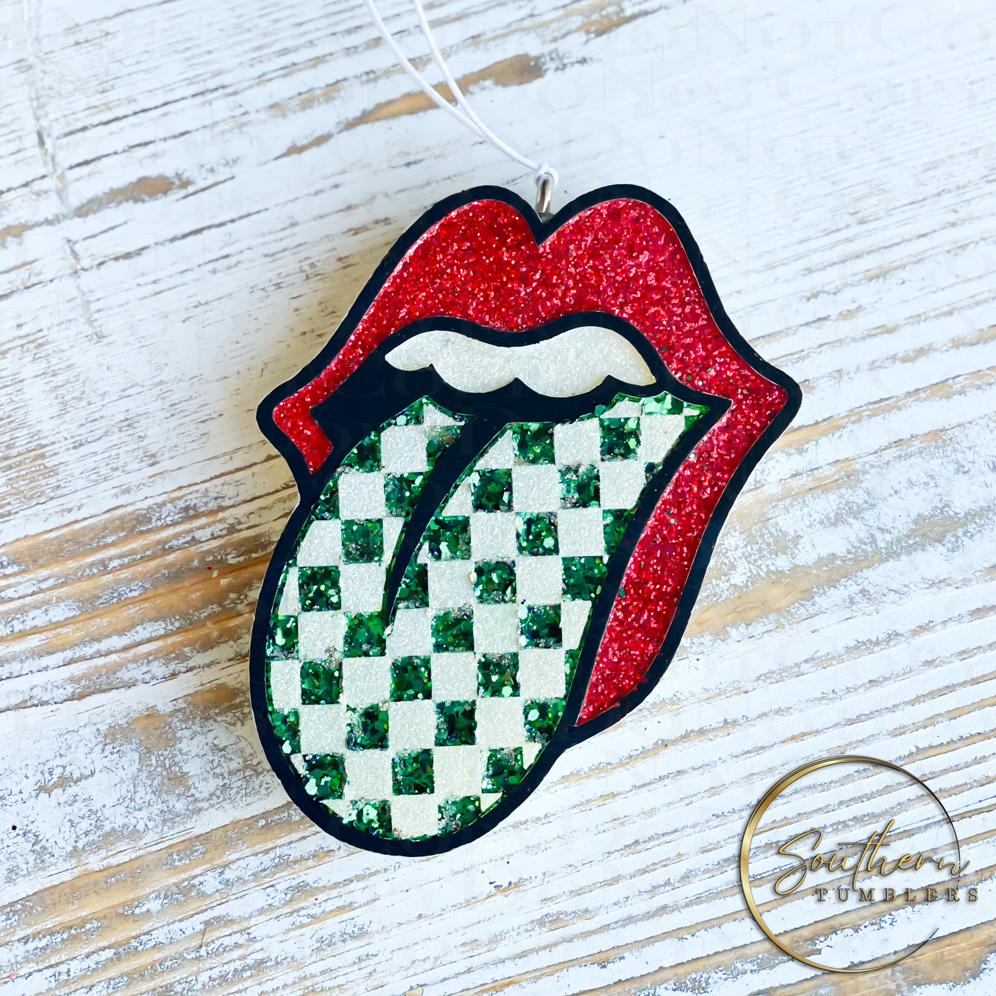 car air freshener in the shape of lips with tongue out with a checker print 