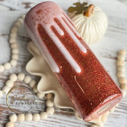 20oz Skinny straight tumbler decorated with glitter and saying tis the season for pumpkin spice lattes topped with a whipped cream drip effect